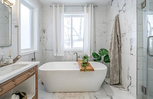 clean marble bathroom with freestanding bathtub