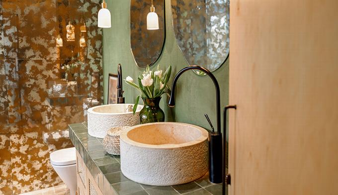 Earthy bathroom design with greens and coppers