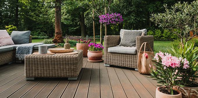 Garden furniture on decking in larger garden